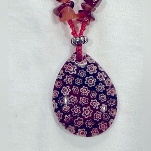 Red-orange stone necklace with oval floral pendant